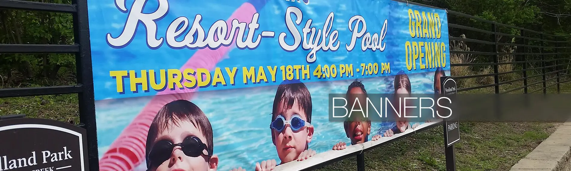 Banner for resort-style pool grand opening.