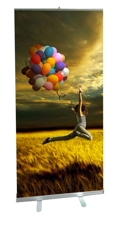 Person jumping with colorful balloons in field.