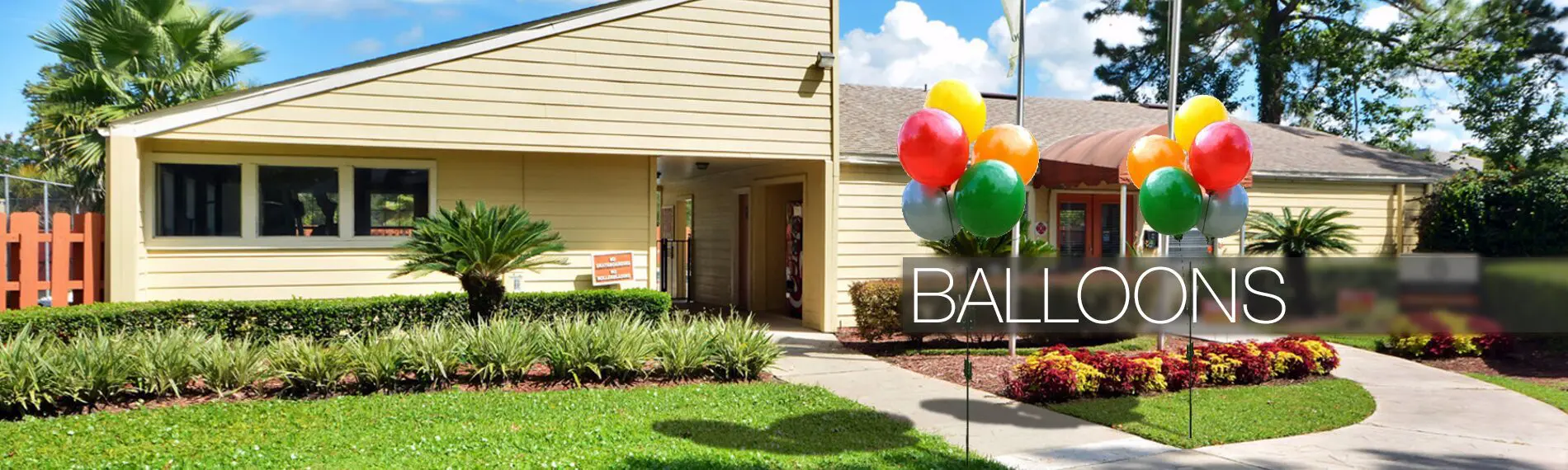 House exterior with colorful balloons outside.