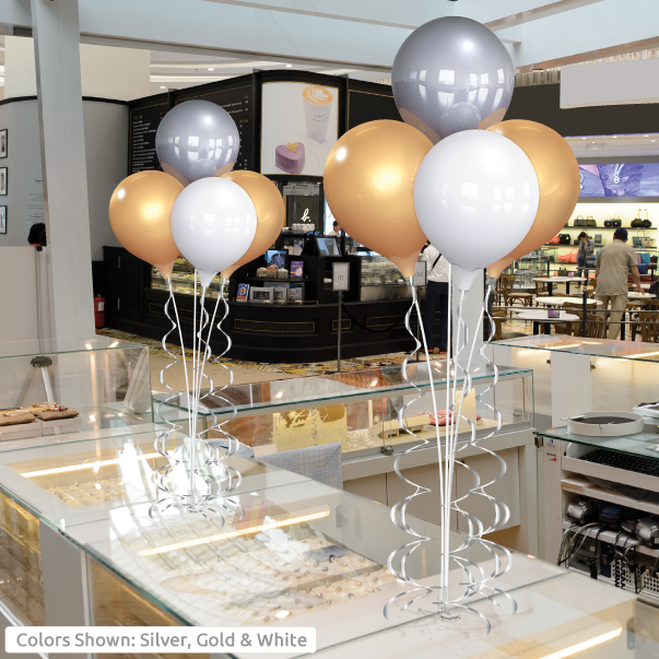 Silver, gold, and white balloons in store.