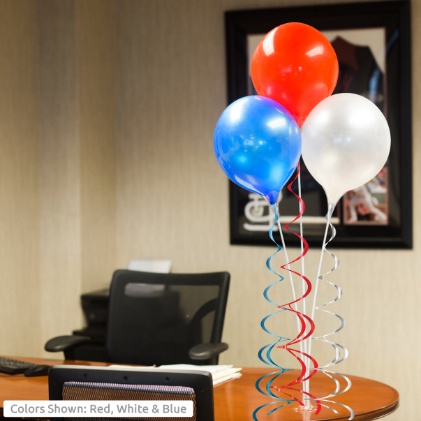 Red, white, blue balloons in office.