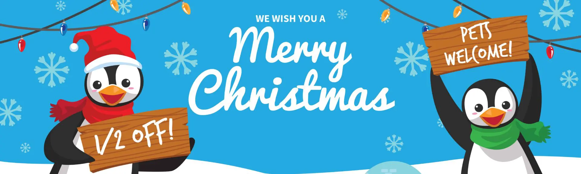 Penguins with Christmas signs in snow.