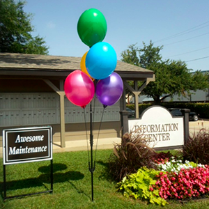 Colorful balloons outside information center building.