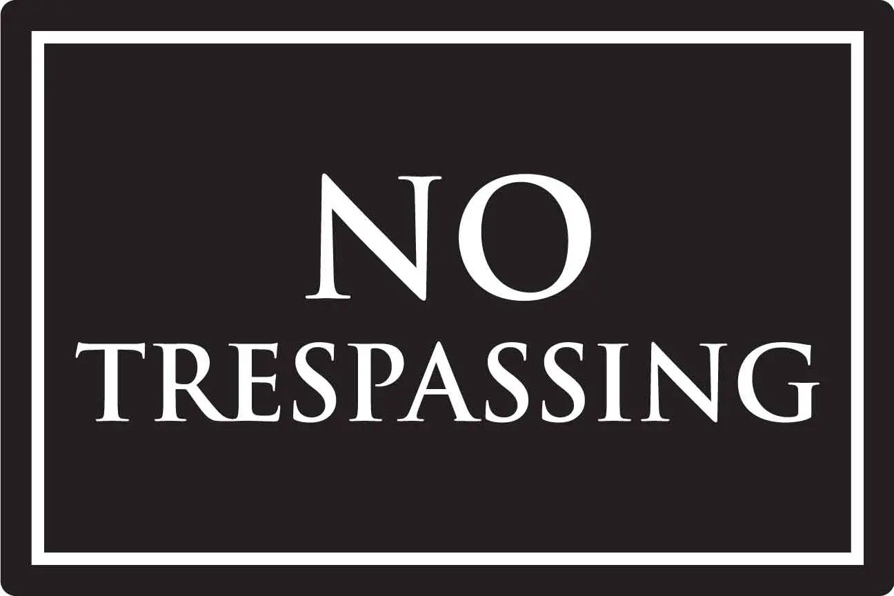 No Trespassing sign with white text.