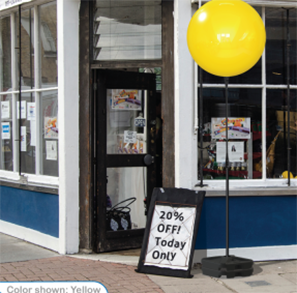 Storefront with sale sign and yellow balloon.