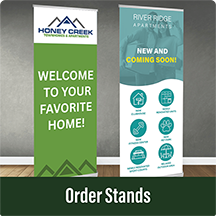 Two vertical apartment promotional retractable banners