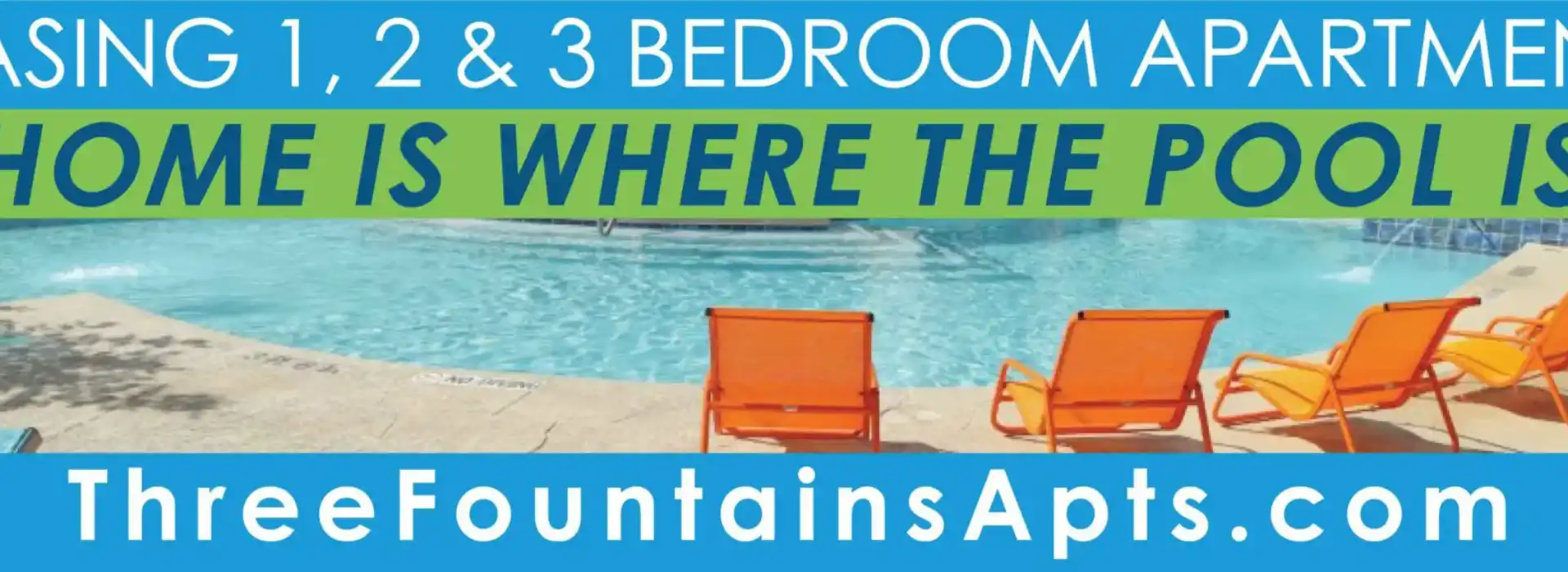 Poolside view with orange chairs at a 3-bedroom apartment complex.