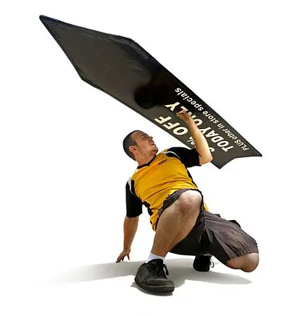 Man holding large black arrow sign.